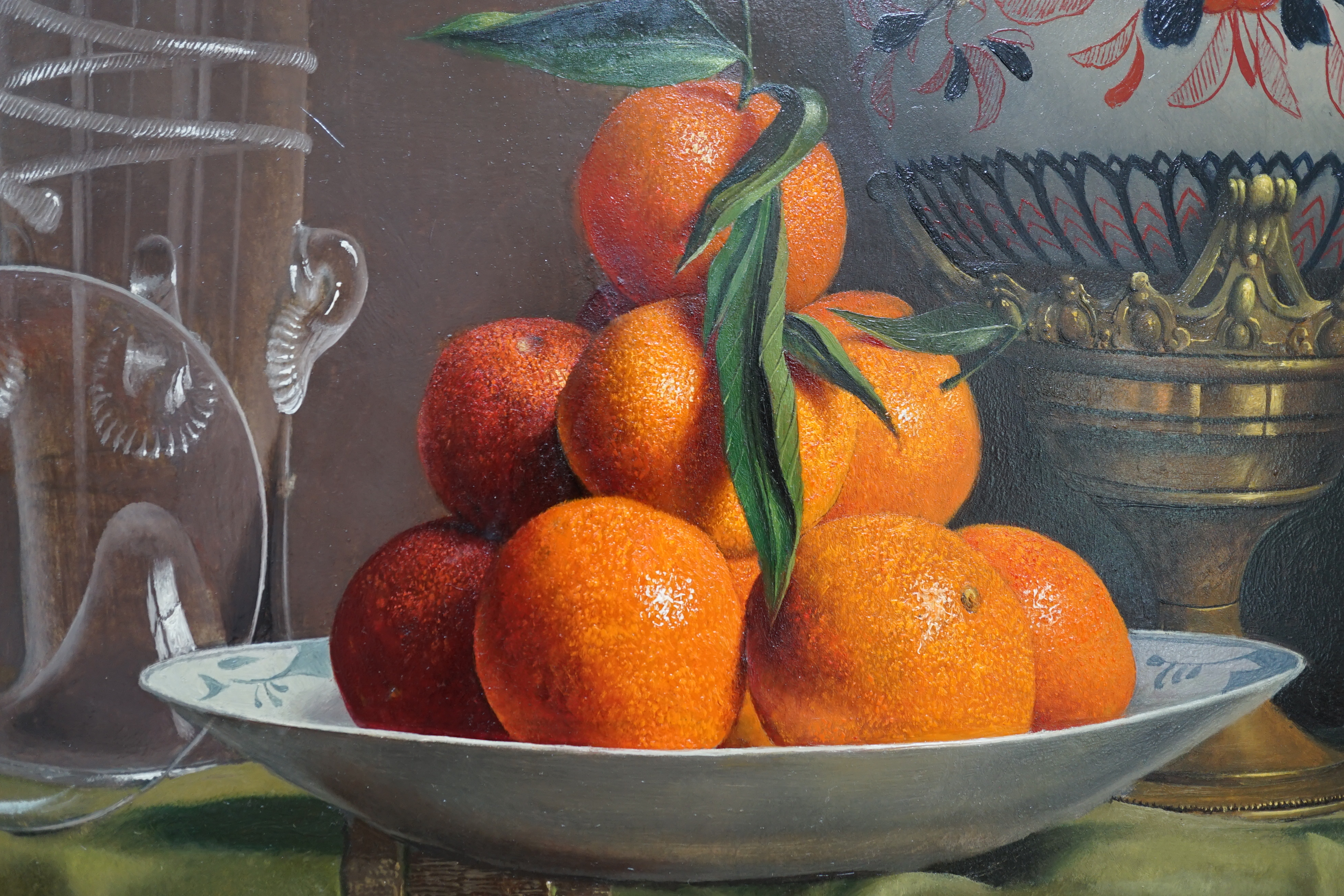 Willem Dolphyn (Belgian, 1935-2016), Still life of oranges, glassware and an ormolu mounted vase upon a draped table, oil on panel, 49 x 58cm
